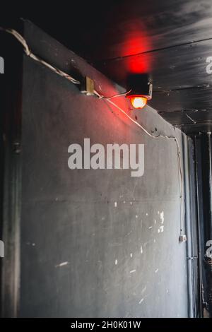Emergency alarm - red light on the ceiling at the emergency exit - emergency evacuation Stock Photo