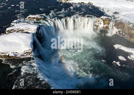 Aerial view of Godafoss waterfall, snowy shore and river. Iceland in early spring Stock Photo