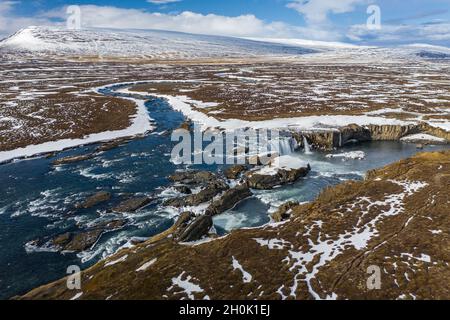 Aerial view of Godafoss waterfall, snowy shore and river. Iceland in early spring Stock Photo