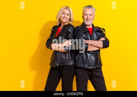 Portrait of attractive pensioner cheerful cool grey-haired friends folded arms isolated over bright yellow color background Stock Photo