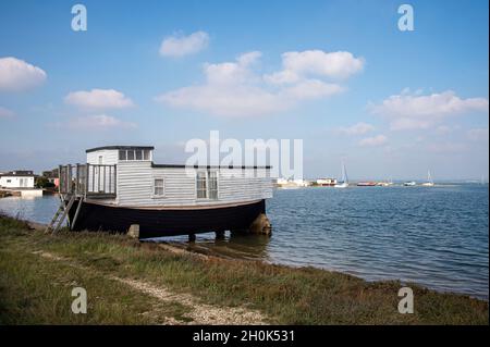 Old wooden houseboat at the Kench on Hayling Island, Hampshire, UK Stock Photo