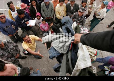 A relief operation for the survivors of a volcanic eruption. The ‘Tungurahua’, an active volcano, in the ‘Cordillera Central’ (a chain of mountains, in the Andes) of Ecuador, erupted on July 14th and August 16th of 2006, devastating life in the small towns on its slope and surroundings. A “river of fire” was formed by over 10 million cubic meters of ash, gravel and incandescent material. More than 3000 people were evacuated from the area with six casualties and around 60 missing. With the alarm of another eruption ahead, the residents enter the emergency zone to work and take care of their hom Stock Photo