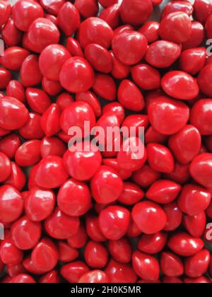 Saga Seed Acacia beans red in colour background Stock Photo