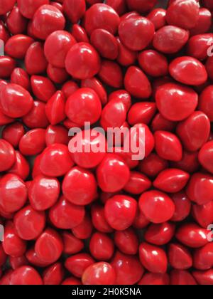 Saga Seed Acacia beans red in colour background Stock Photo