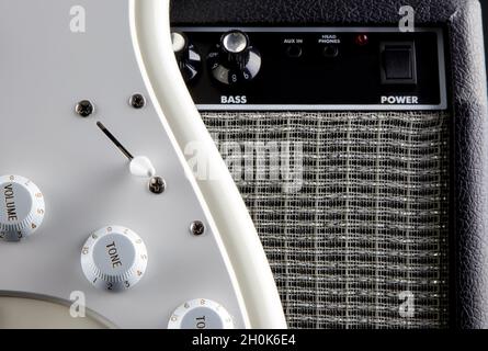 Closeup view of white electric guitar and amplifier Stock Photo