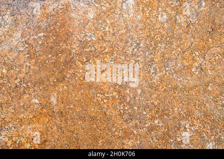 Raw rough yellow golden brown granite texture background. Natural rock stone texture background. Granite Grades. Muscovite colored minerals in granite Stock Photo