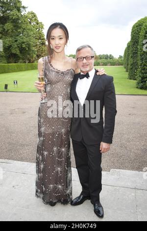 Ballet Dancer Jia Zhang (wearing Jacques Azagury) and Jacques Azagury at English National Ballet's Summer Party at The Orangery, Kensington Palace, London, 29th June 2011. Stock Photo