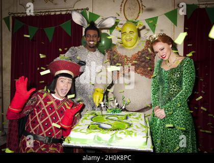 Neil McDermott who plays Lord Farquaad, Richard Blackwood who plays Donkey,  Dean Chisnell who plays Shrek and Kimberley Walsh who plays Princess Fiona  cut the cake at Shrek The Musical 1 Year