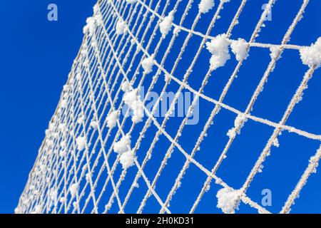 Volleyball net covered with snow. Nature's minimalism.  Stock Photo