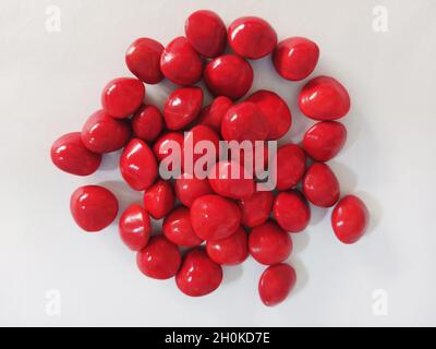 Saga Seed Acacia beans red in colour background Stock Photo