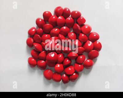 Saga Seed Acacia beans red in colour background Stock Photo