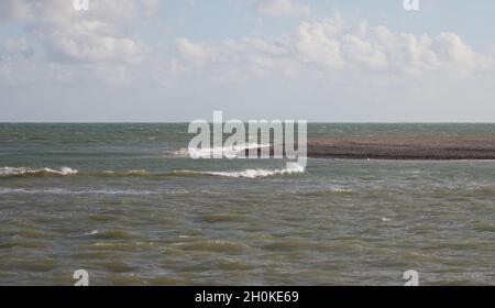 Waves rolling over gently near the shore. Stock Photo