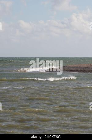 Waves rolling over gently near the shore. Stock Photo