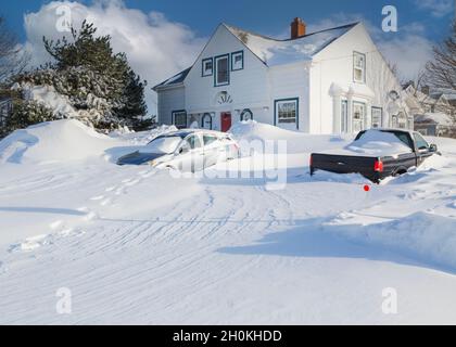Unplowed driveway of a traditional older home after a blizzard in a North American suburban neighborhood. Stock Photo
