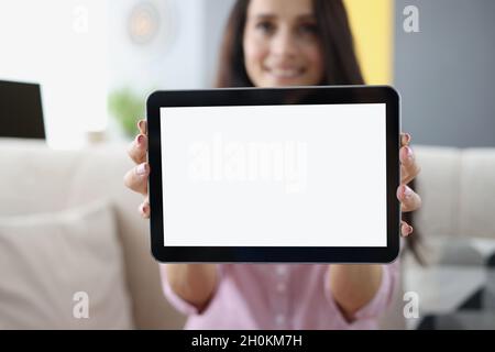 Young woman holding in hands and showing digital tablet closeup Stock Photo