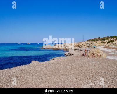 Fisherman at Ostriconi beach with turquoise water. Desert des Agriates, Corsica, France. Stock Photo