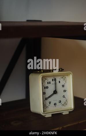 Closeup of an old classical clock on a wooden Stock Photo