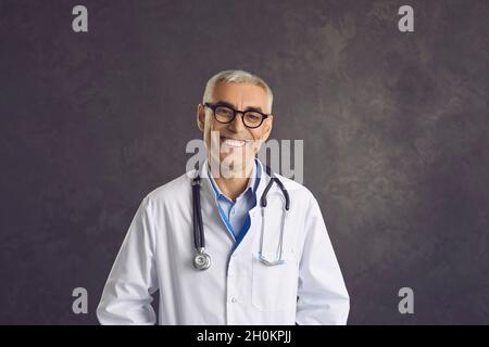 Portrait of smiling middle-aged man doctor in white uniform Stock Photo