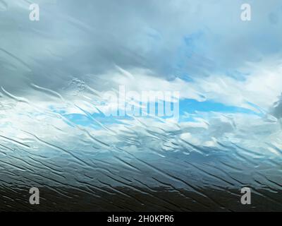 Rain Streaks Across a Car Windscreen on an Exposed Beach in North Norfolk, England,UK Stock Photo