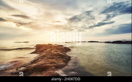 Scenic sunset at a rocky beach in Bentota, Sri Lanka. Stock Photo