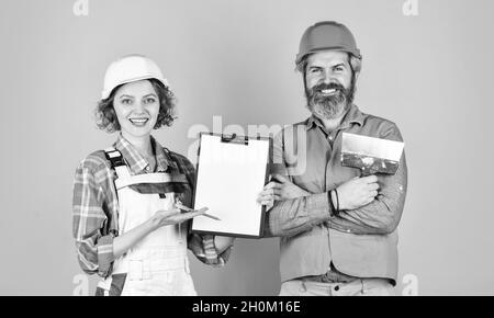 confident electrical and technician. engineers couple working together on building blueprint. work at construction site or factory. Civil engineering Stock Photo