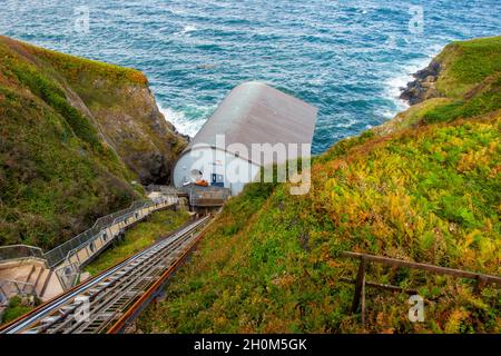 Funicular railway leading to the Lizard RNLI Lifeboat Station at the foot of cliffs on the Lizard in south west Cornwall England UK Stock Photo