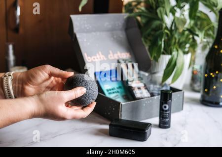 Bath detox beauty box with black charcoal cosmetic and beauty devices. Beauty box with Konjac Sponge, Cleansing Oil, Beauty Mask, Soap Bar, Bamboo Too Stock Photo