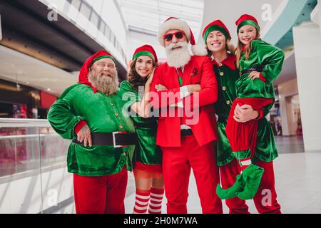 Portrait of attractive cheerful trendy friends elfs folded arms spending eve advent dream time visiting store mall market indoors Stock Photo