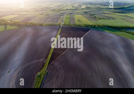 Aerial image of agricultural field with center pivot irrigation systems forming round shape field, shoot from drone Stock Photo