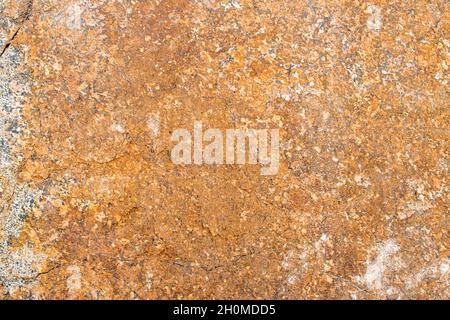 Raw rough yellow golden brown granite texture background. Natural rock stone texture background. Granite Grades. Muscovite colored minerals in granite Stock Photo