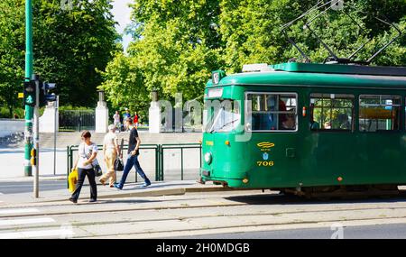 POZNAN, POLAND - Oct 18, 2015: The People passing the street with waiting green tram in the city center Stock Photo