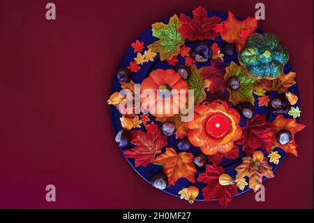Colorful and autumn Halloween decoration with leaves, pumpkins and candle. Stock Photo