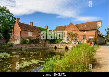 View to the Flatford Mill red brick buildings from the road next to river Stour, Suffolk, England. Stock Photo