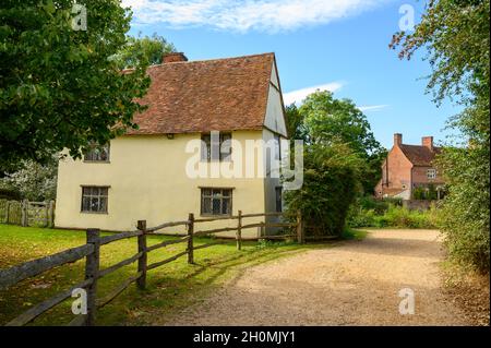 The historic cottage Willy Lott's House seen from the road near Flatford Mill (seen to the right) in Flatford, Suffolk, England. Stock Photo