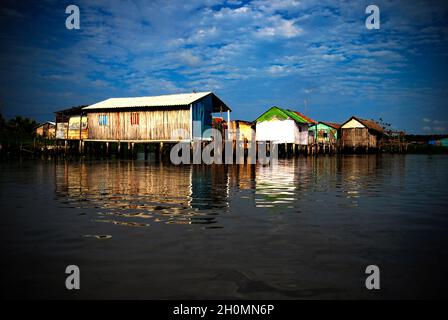 The Sinamaica lagoon is a large extension of water located northwest of Zulia state, Venezuela. The Sinamacia village inhabited by the ethnic Añu Indians is one of the last floating villages on earth. They have been living in the area in houses above water known as palafitos, since pre-colonial times. They use the water body for fishing, transport, and other activities. Wooden canoes or small motor boats are used for transportation. Life in the lagoon is currently threatened by social issues such as severe poverty, water contamination and global warming. Bolivian Republic of Venezuela. March 3 Stock Photo