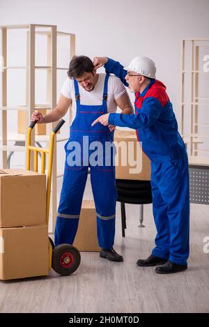 Two professional movers doing home relocation Stock Photo