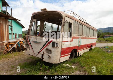 Pilcopata, Peru - April 12, 2014: An old, rusty, dusty and abandoned Fuso bus, rests in the surroundings of the small town of Pilcopata Stock Photo