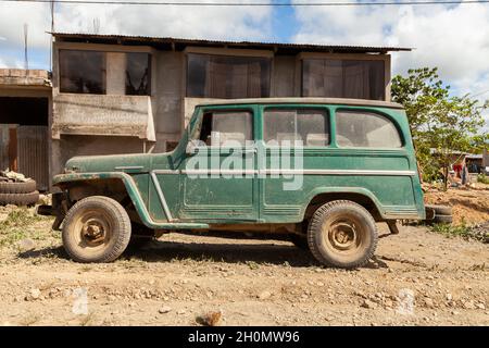 Pilcopata, Peru - April 12, 2014: An old off-road vehicle of green color, parked in one of the streets of the small town of Pilcopata Stock Photo