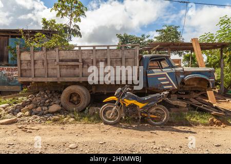 Pilcopata, Peru - April 12, 2014: An old rusty and abandoned truck, half scrapped, rests in one of the streets of Pilcopata Stock Photo