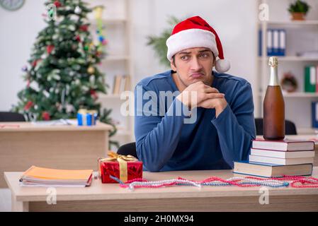 Young student preparing for exams during new year celebration Stock Photo