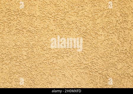 Decorative plaster background. Outdoor Conserving Decorative Textured Brown Yellow Plaster background Stock Photo