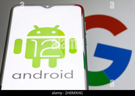 Android is a mobile operating system. The twelfth version of the Android operating system developed by Google. Android 12 logo on smartphone screen. Stock Photo