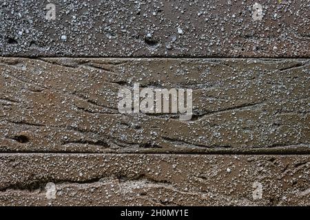 Close-up texture of a brown decorative scratched brick with a gap Stock Photo