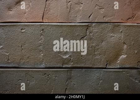 Close-up texture of a brown decorative scratched brick with a gap Stock Photo