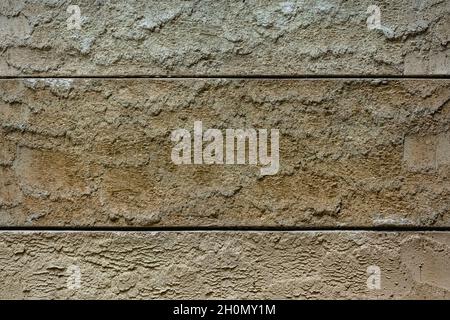 Close-up texture of a brown decorative scratched brick with a gap Stock Photo