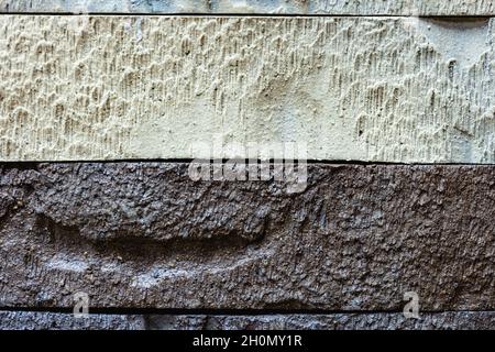 Close-up texture of a brown and white decorative scratched brick with a gap Stock Photo