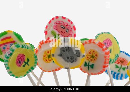 Set of lollipops on white background. Big bright tasty lollipops on white sticks on white background with copy space. Sweet candy concept Stock Photo