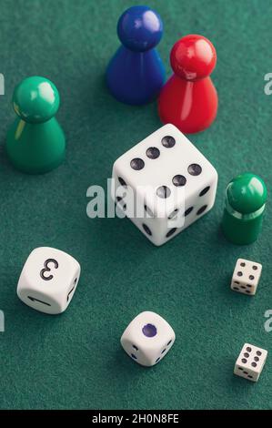 Colored board game figures with dice. Board games concept. Stock Photo