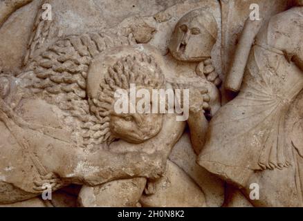 Siphnian Treasury, ca. 525 BC. Marble of Paros. North frieze depicting a Gigantomachy. A lion biting a giant. Archaeological Museum of Delphi, Greece. Stock Photo