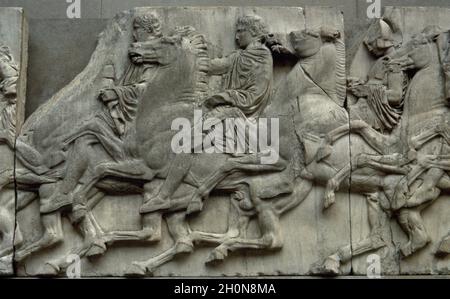 Slab of the North frieze of the Parthenon of Athens. Relief depicting three riders in the Procession of the Panathenaic festival, the commemoration of Stock Photo